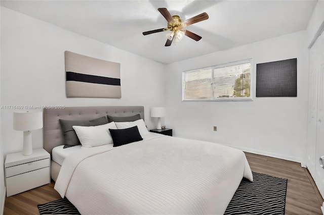 bedroom featuring hardwood / wood-style flooring, ceiling fan, and a closet