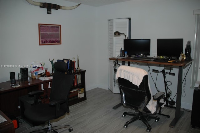 office area featuring baseboards and wood finished floors