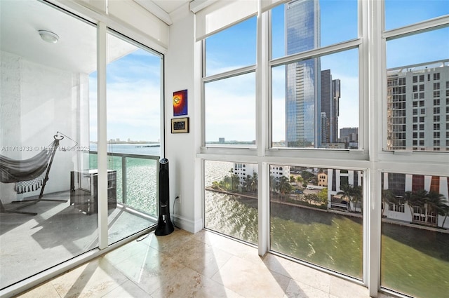 sunroom / solarium with a water view