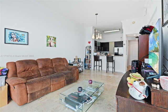 living room featuring crown molding and a notable chandelier