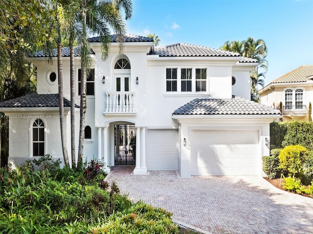 mediterranean / spanish home with a balcony and a garage