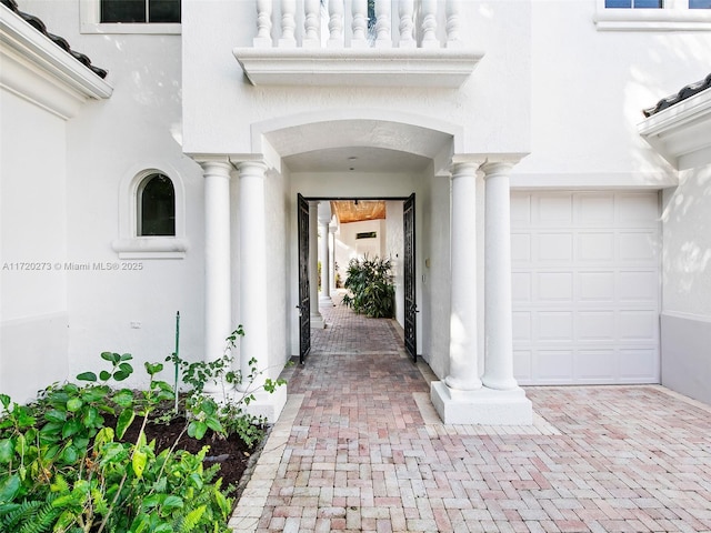 doorway to property with a garage