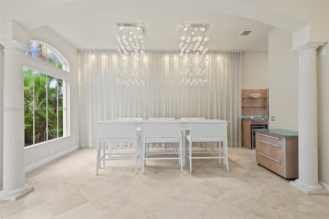 unfurnished dining area with a chandelier, ornate columns, and beverage cooler