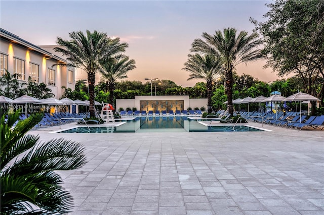 view of pool at dusk