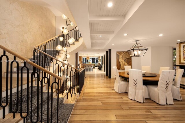 interior space featuring beam ceiling, wood ceiling, and wood-type flooring