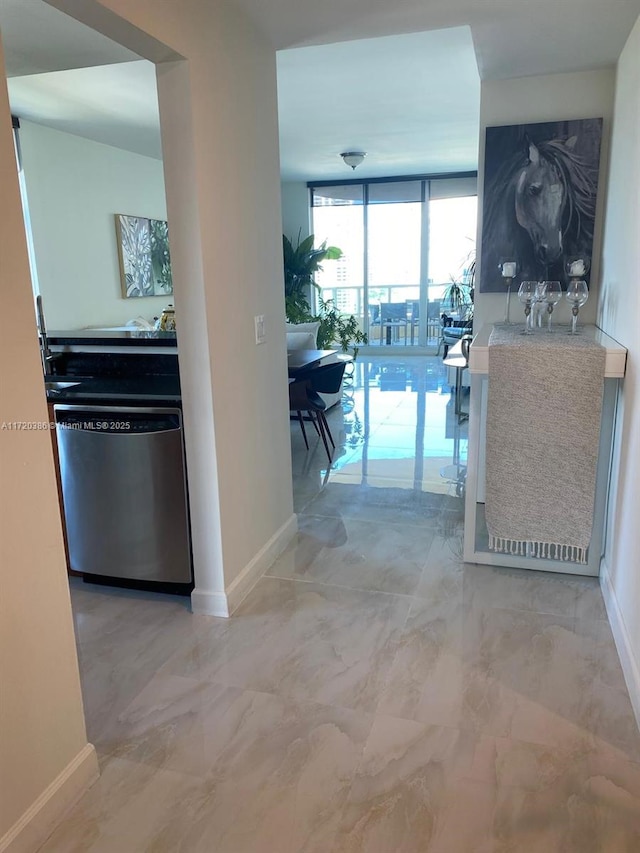 3340 NE 190th St Unit 1101, Aventura, FL 33180 - hallway with expansive windows and marble look tile flooring