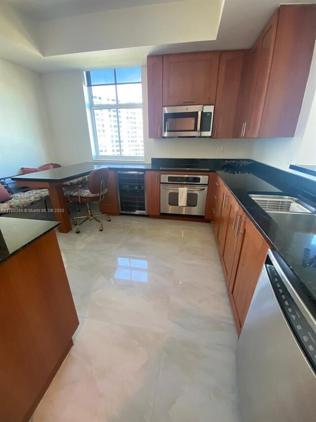 3340 NE 190th St Unit 1101, Aventura, FL 33180 - kitchen with appliances with stainless steel finishes, beverage cooler, dark countertops, and brown cabinets