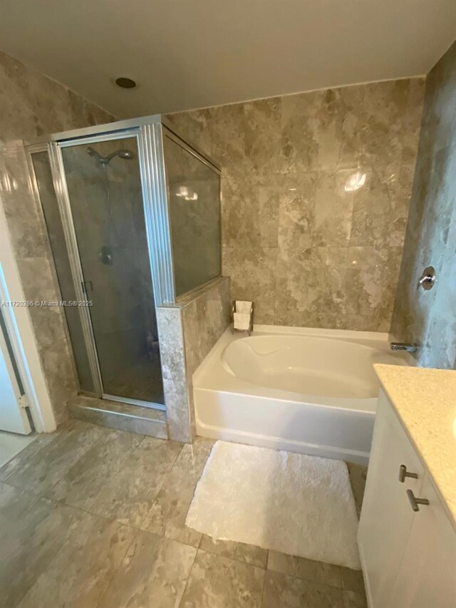 bathroom with shower with separate bathtub and vanity