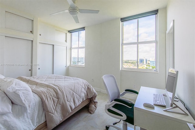 bedroom featuring multiple windows and ceiling fan