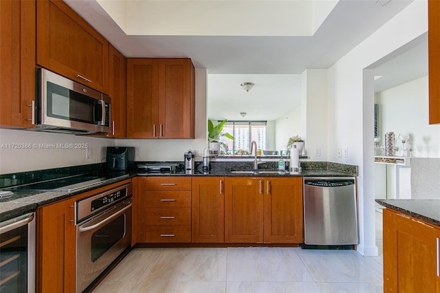 3340 NE 190th St Unit 1101, Aventura, FL 33180 - kitchen with stainless steel appliances, dark stone countertops, and brown cabinets