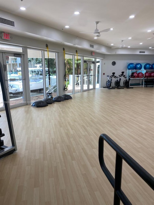 exercise room with ceiling fan, light hardwood / wood-style floors, and french doors