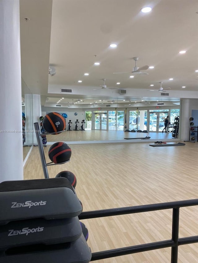 workout area featuring hardwood / wood-style flooring and ceiling fan