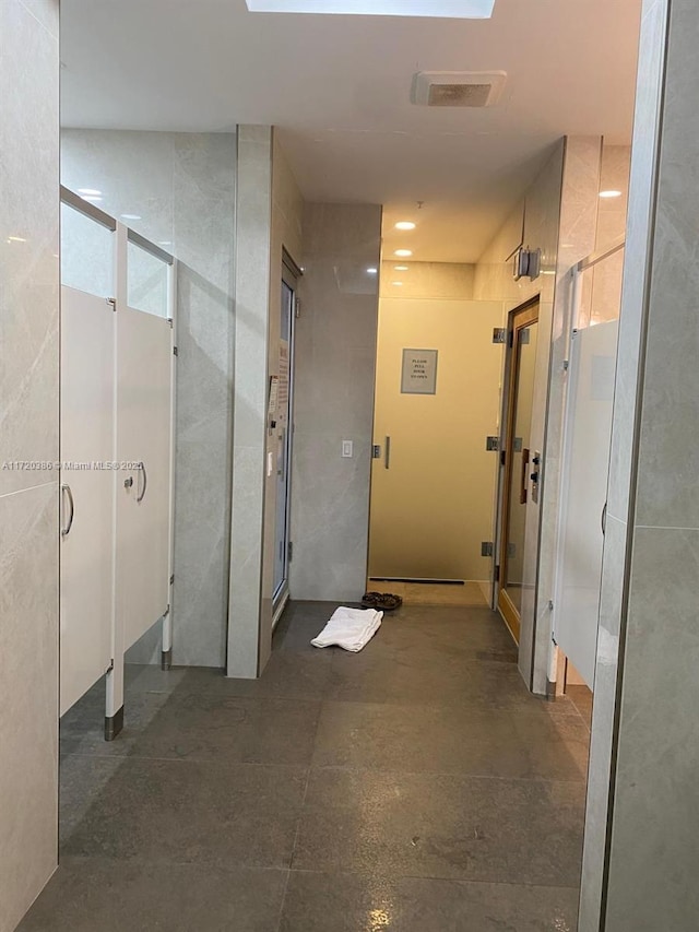 bathroom featuring a shower with door