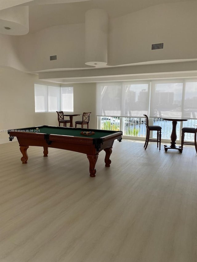 game room with a healthy amount of sunlight, light hardwood / wood-style floors, and pool table