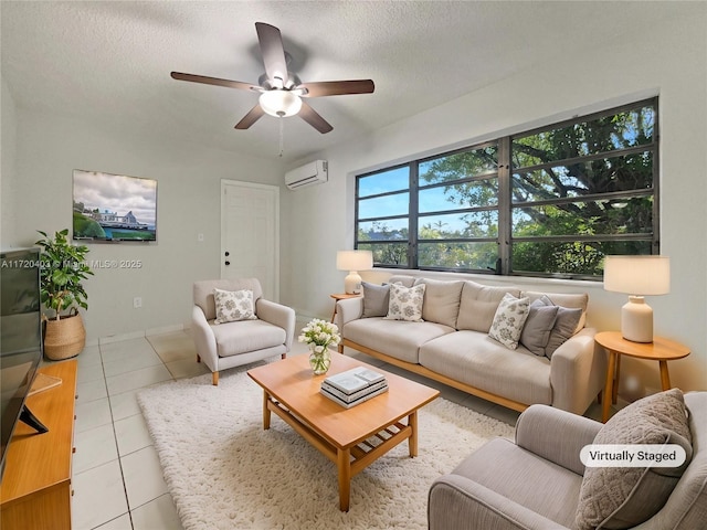 living room featuring ceiling fan, light tile patterned floors, a textured ceiling, and a wall mounted AC