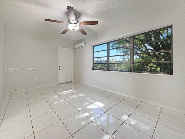 unfurnished room featuring a textured ceiling, ceiling fan, light tile patterned floors, and a wall mounted air conditioner