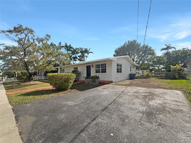 ranch-style home with a front yard