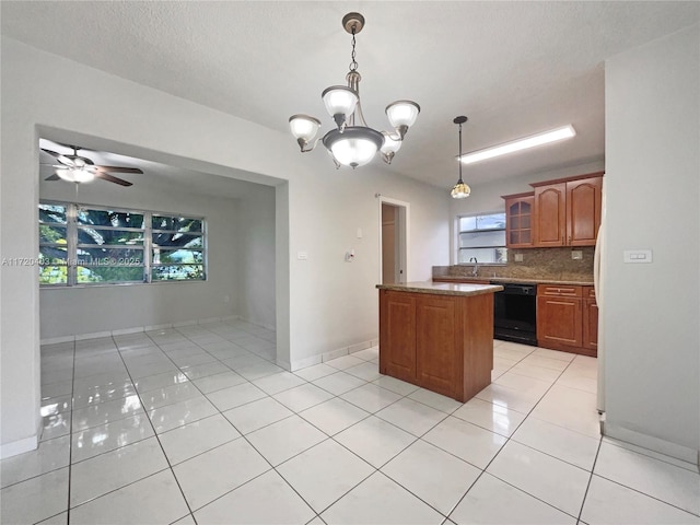 kitchen featuring hanging light fixtures, black dishwasher, decorative backsplash, light tile patterned floors, and ceiling fan with notable chandelier