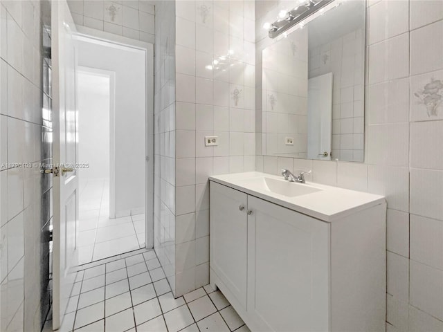 bathroom featuring tile patterned floors, vanity, and tile walls