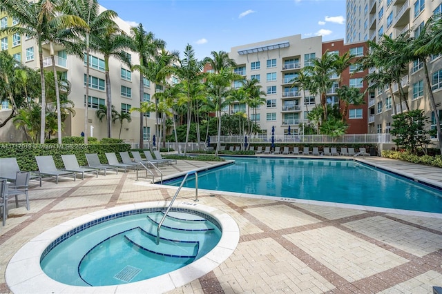 view of pool with a community hot tub and a patio