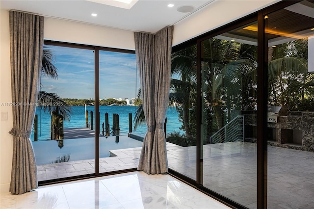 doorway to outside with a water view