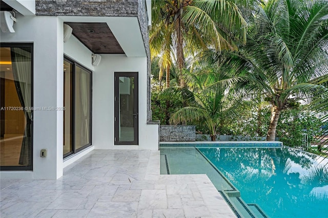 view of pool featuring a patio