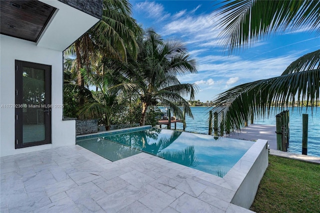 view of swimming pool featuring a water view