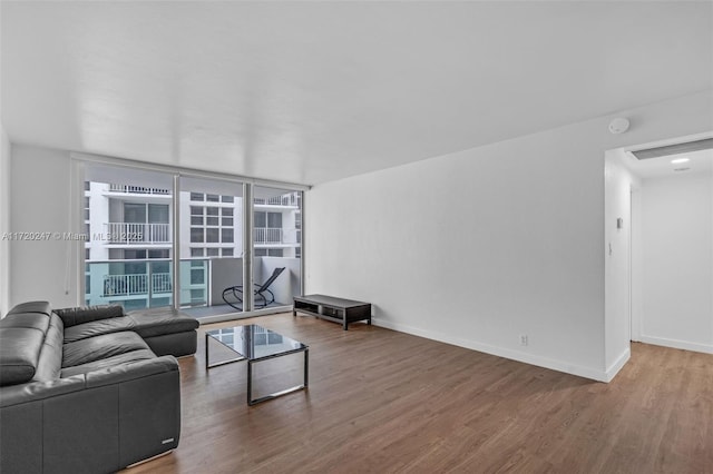 living room featuring hardwood / wood-style floors and a wall of windows