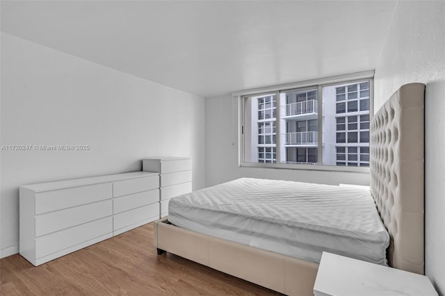 bedroom with wood-type flooring