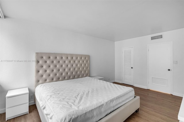 bedroom with wood-type flooring