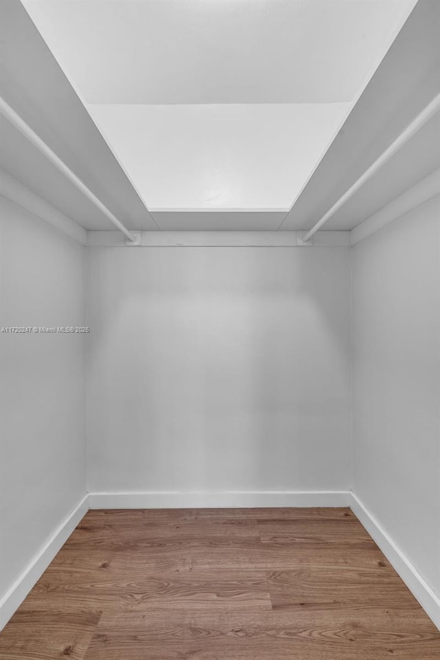 walk in closet featuring hardwood / wood-style flooring