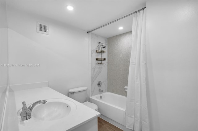 full bathroom featuring vanity, toilet, wood-type flooring, and shower / tub combo