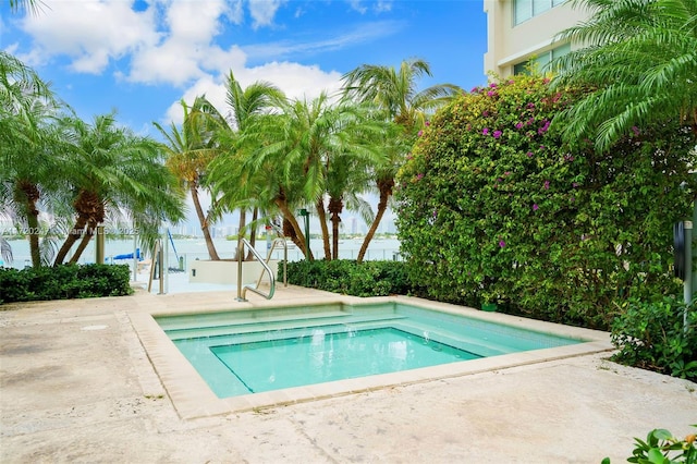 view of swimming pool featuring a water view