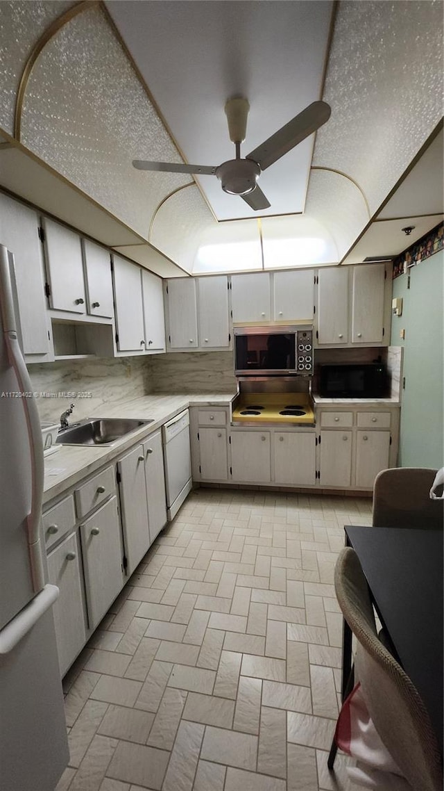 kitchen with ceiling fan, sink, white cabinets, and white appliances