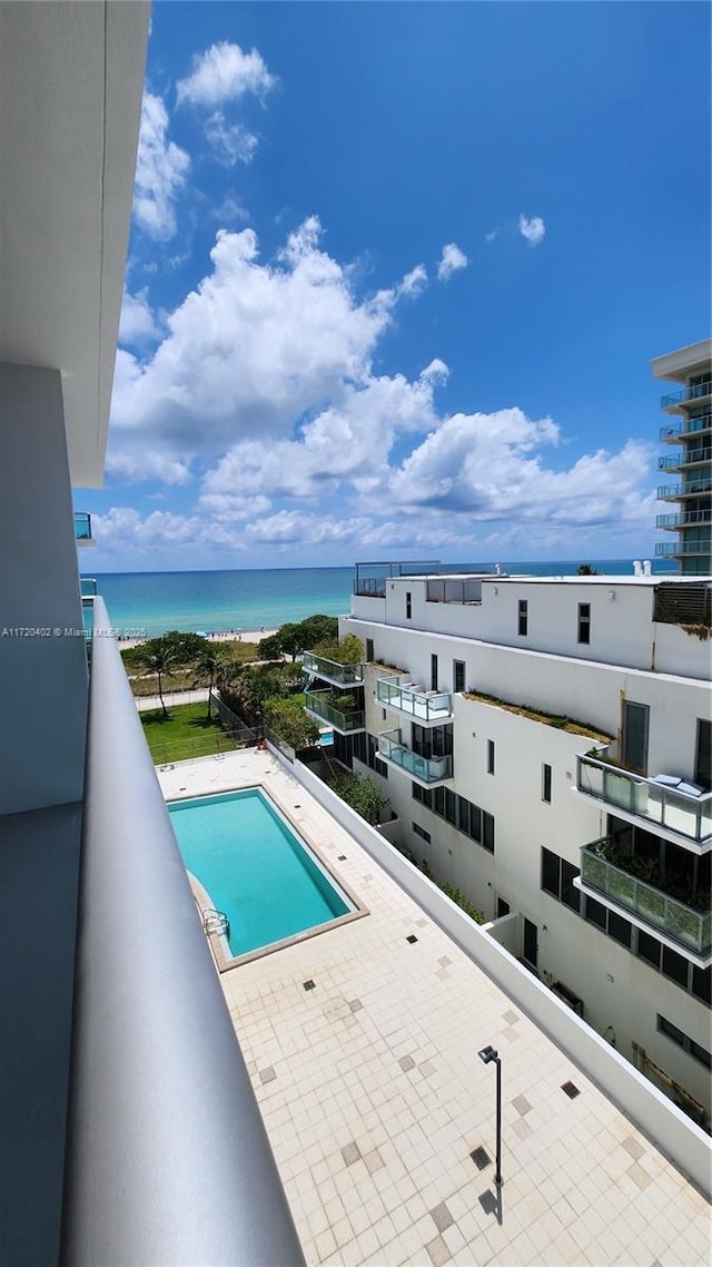 view of swimming pool featuring a water view