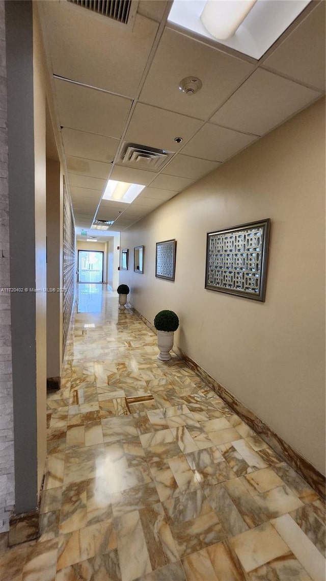 hallway with a drop ceiling