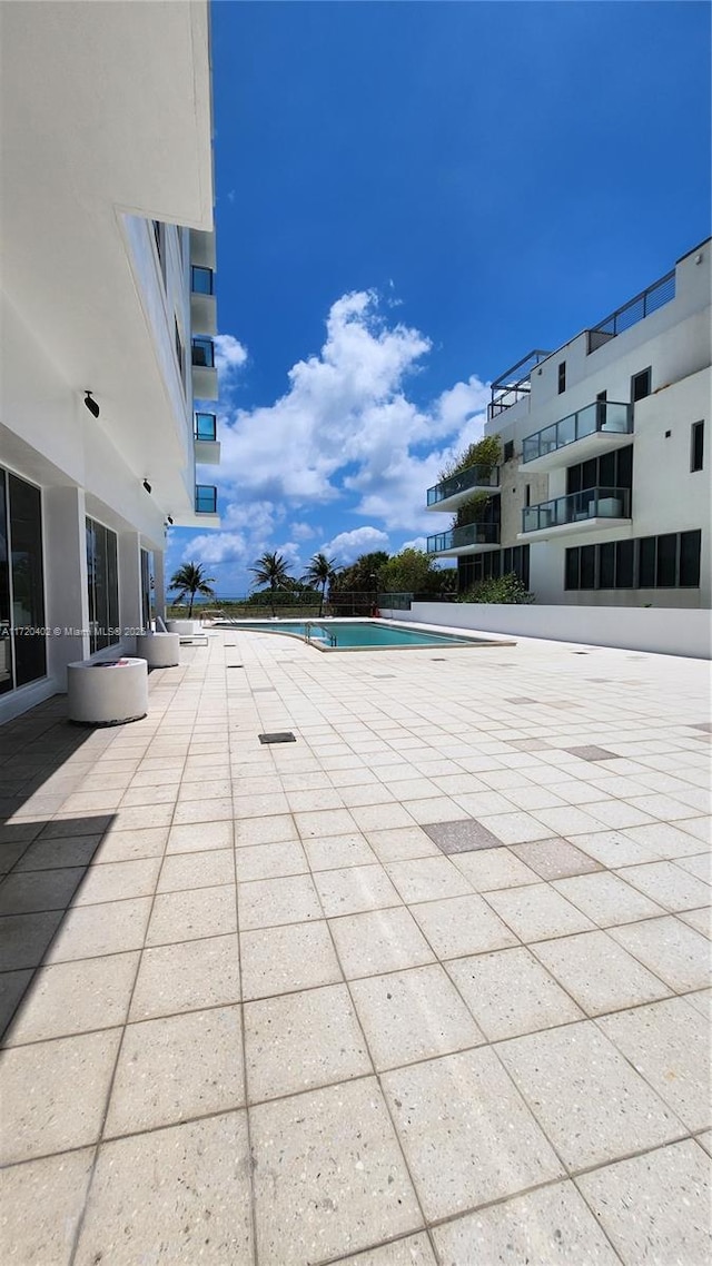 view of swimming pool featuring a patio