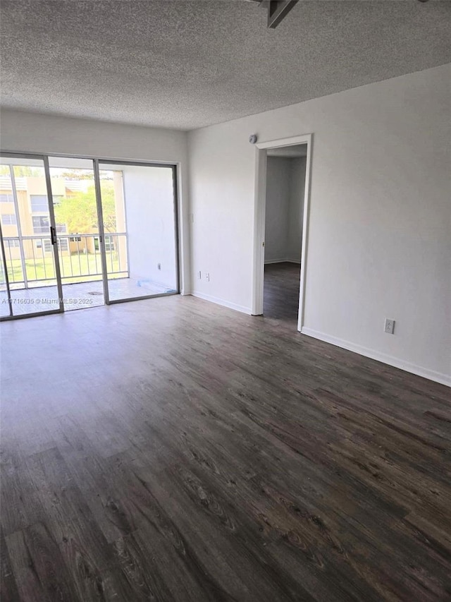 unfurnished room featuring dark hardwood / wood-style floors and a textured ceiling