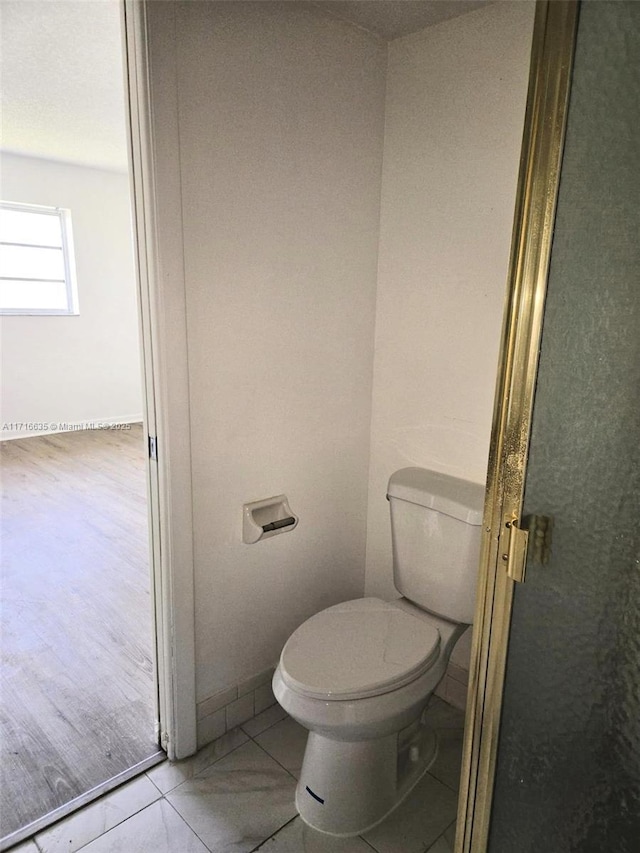 bathroom with tile patterned floors and toilet