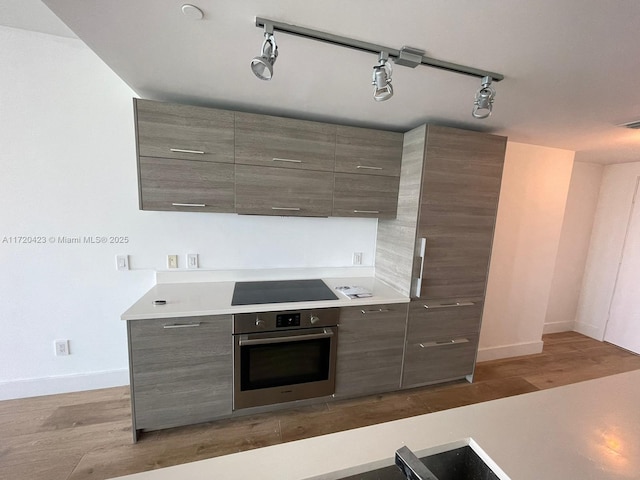 650 NE 32nd St Unit 1805, Miami, FL 33137 - kitchen featuring stainless steel oven, black electric stovetop, and light countertops