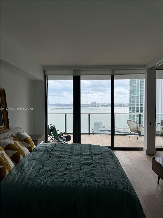 650 NE 32nd St Unit 1805, Miami, FL 33137 - bedroom featuring a wall of windows, a water view, multiple windows, and access to outside