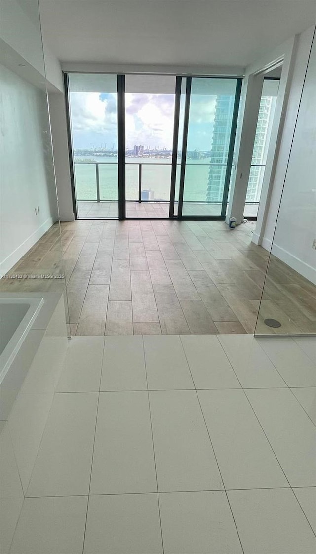 650 NE 32nd St Unit 1805, Miami, FL 33137 - empty room featuring a wall of windows and tile patterned flooring