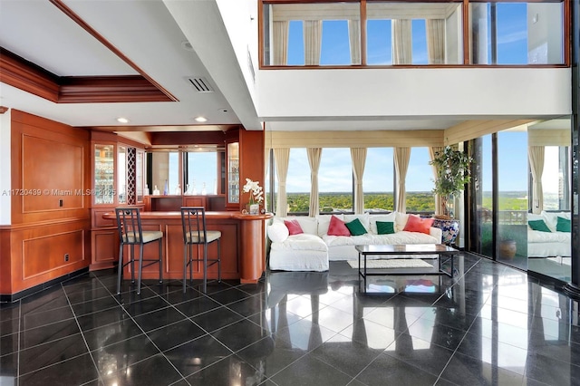 living room with crown molding and a high ceiling