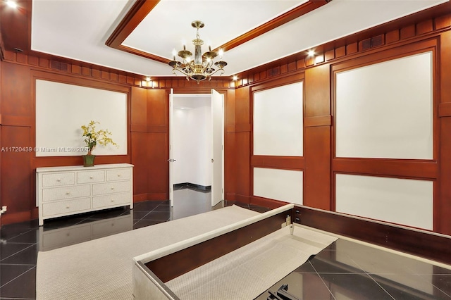 interior space with dark tile patterned floors and a notable chandelier