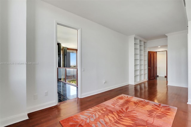 interior space featuring hardwood / wood-style flooring, built in features, and ornamental molding