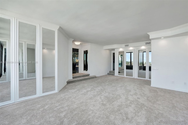 carpeted empty room featuring ornamental molding