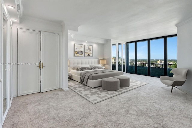 carpeted bedroom with access to outside, floor to ceiling windows, and ornamental molding