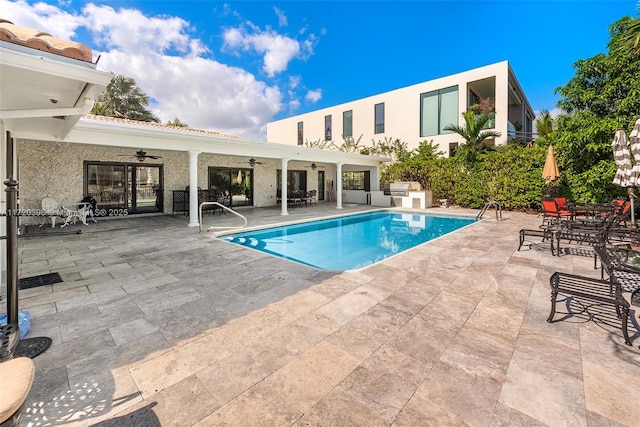 view of pool with ceiling fan and a patio area