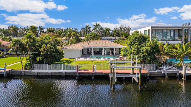 back of property with a yard and a water view