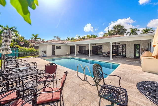 view of pool with ceiling fan and a patio